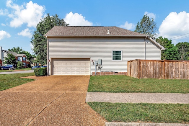 view of home's exterior with a yard and a garage