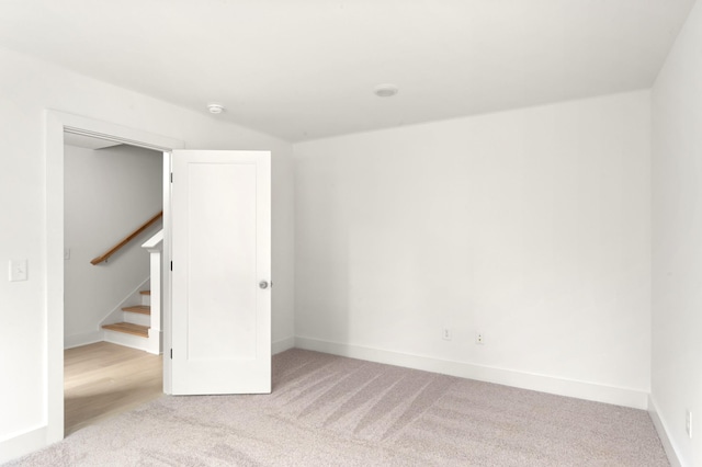 unfurnished room with light colored carpet