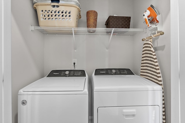 clothes washing area featuring separate washer and dryer