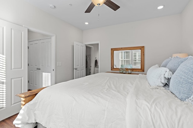 bedroom featuring ceiling fan, a closet, and hardwood / wood-style flooring