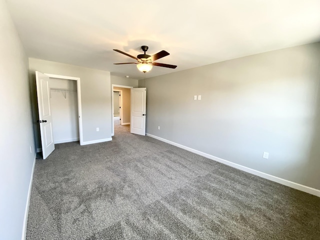 unfurnished bedroom featuring ceiling fan, a closet, and dark colored carpet