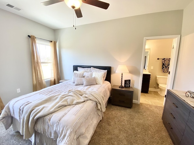 carpeted bedroom featuring ensuite bathroom and ceiling fan