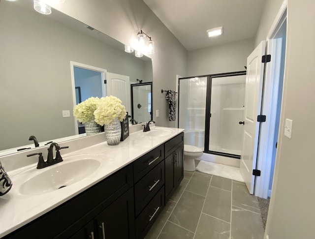 bathroom featuring tile patterned flooring, an enclosed shower, vanity, and toilet