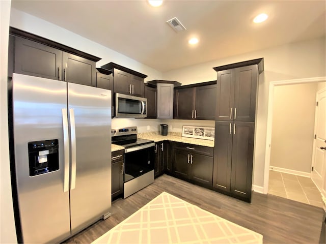 kitchen featuring light hardwood / wood-style floors and appliances with stainless steel finishes