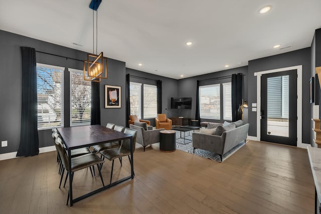 dining room with a chandelier, wood-type flooring, and plenty of natural light