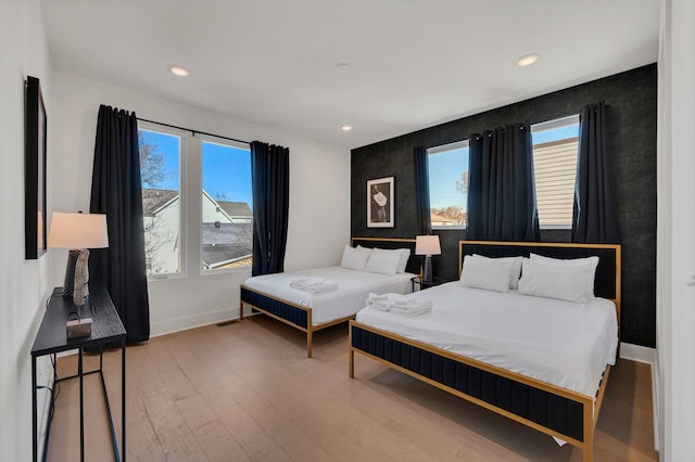 bedroom featuring hardwood / wood-style flooring and multiple windows