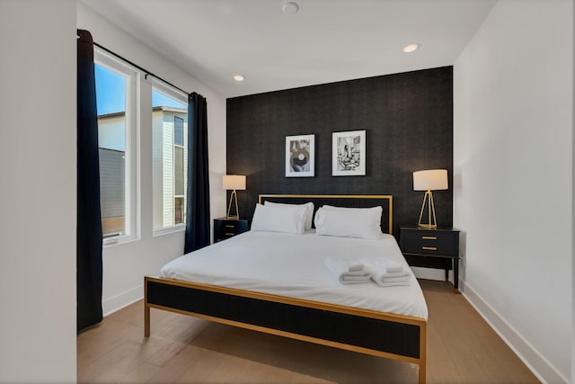 bedroom featuring light hardwood / wood-style flooring and multiple windows