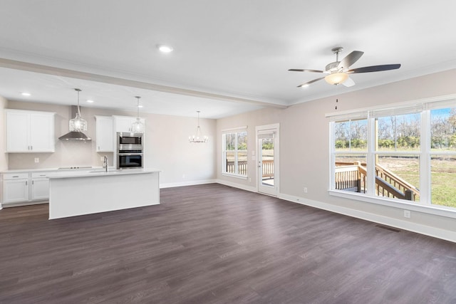 unfurnished living room featuring sink, dark wood-type flooring, ceiling fan with notable chandelier, and beam ceiling