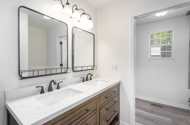 bathroom with vanity and hardwood / wood-style flooring