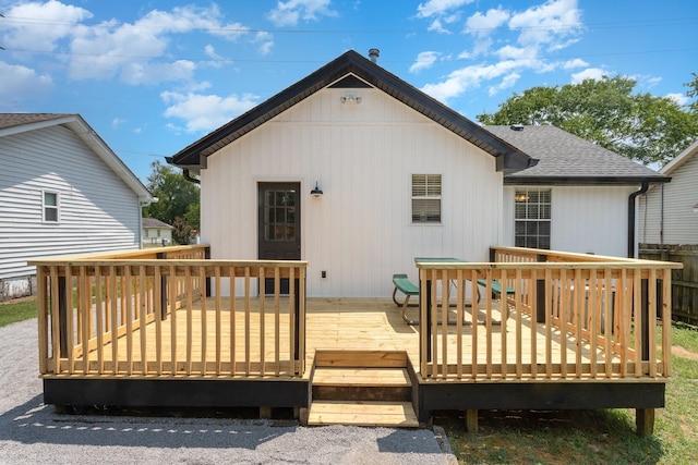 rear view of house featuring a wooden deck