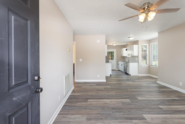 interior space with ceiling fan and dark hardwood / wood-style floors