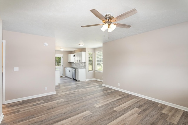 unfurnished living room featuring light hardwood / wood-style floors and ceiling fan