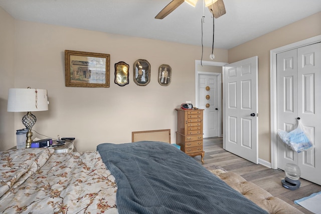 bedroom featuring light wood-type flooring, ceiling fan, and a closet