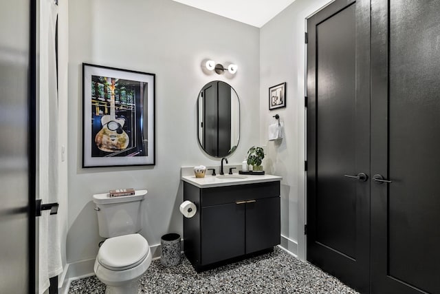 bathroom featuring toilet and vanity