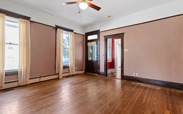 empty room featuring ceiling fan and hardwood / wood-style floors