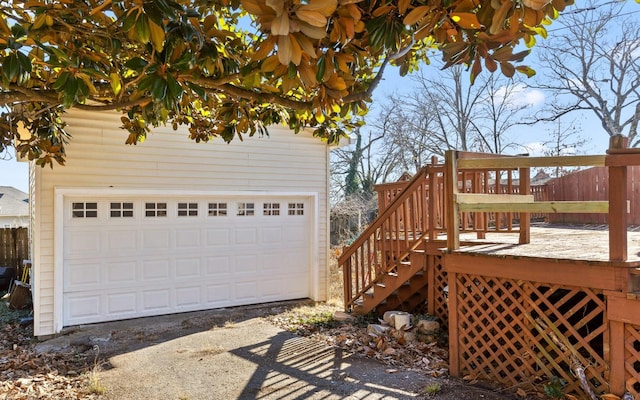 exterior space featuring a wooden deck, a garage, and an outdoor structure