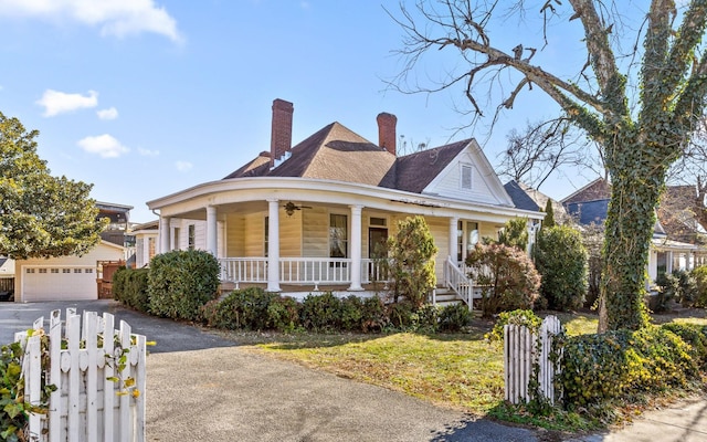 view of front of house featuring a porch and a garage