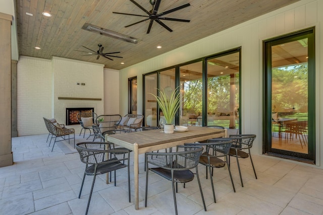 view of patio / terrace with an outdoor brick fireplace and ceiling fan