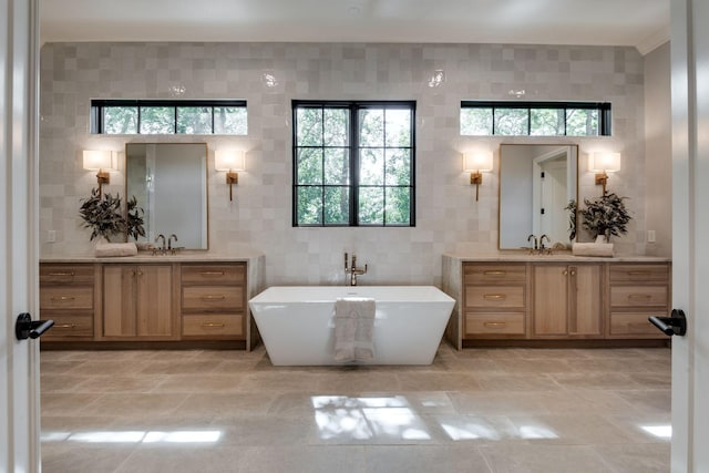 bathroom featuring vanity, tile walls, and a tub