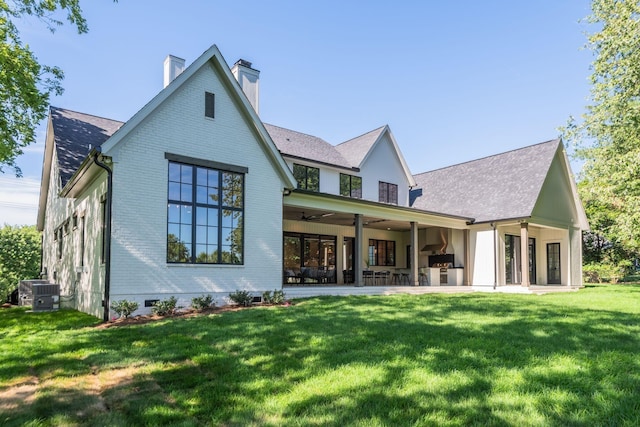 rear view of house featuring central air condition unit, a patio, ceiling fan, and a yard