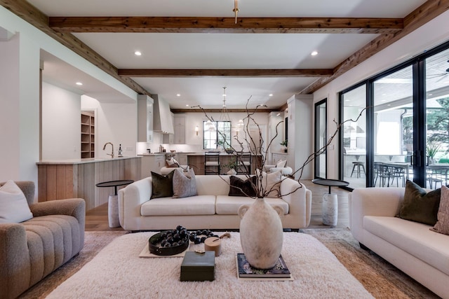 living room with light hardwood / wood-style floors and beamed ceiling