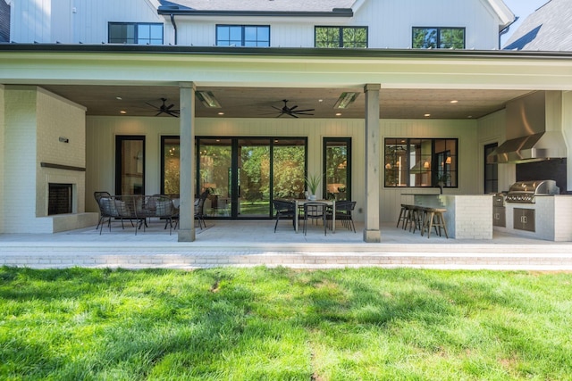 back of property featuring a patio, ceiling fan, a lawn, and area for grilling