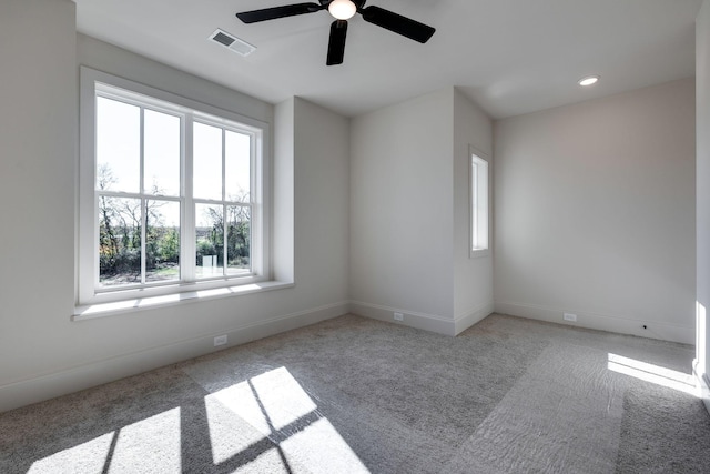 carpeted spare room with ceiling fan