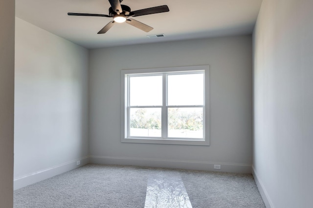 carpeted spare room featuring ceiling fan