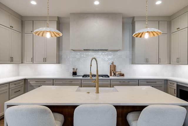 kitchen featuring a kitchen island, gray cabinets, and tasteful backsplash