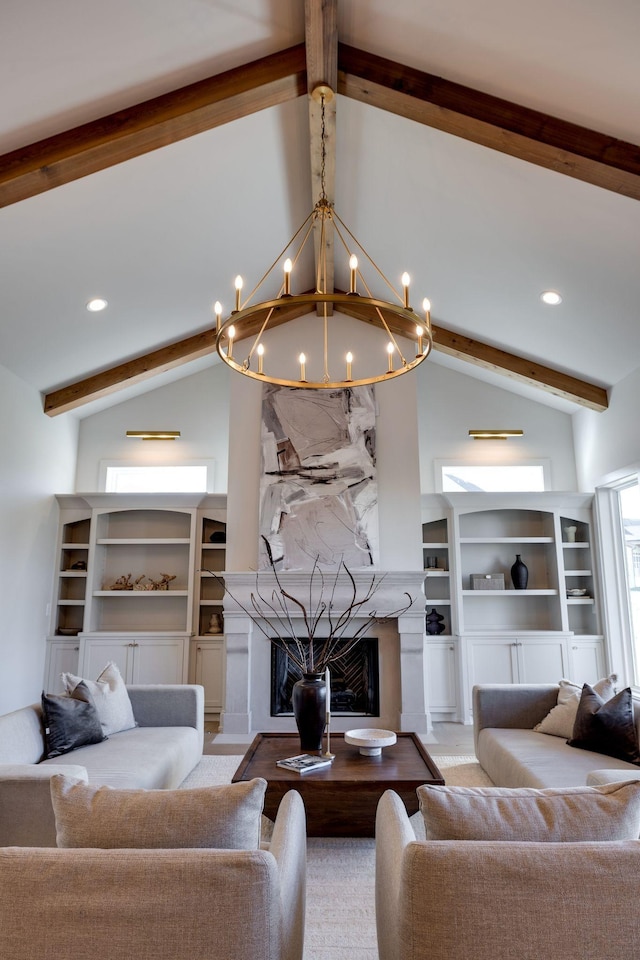 living room with a high end fireplace, a notable chandelier, and lofted ceiling with beams