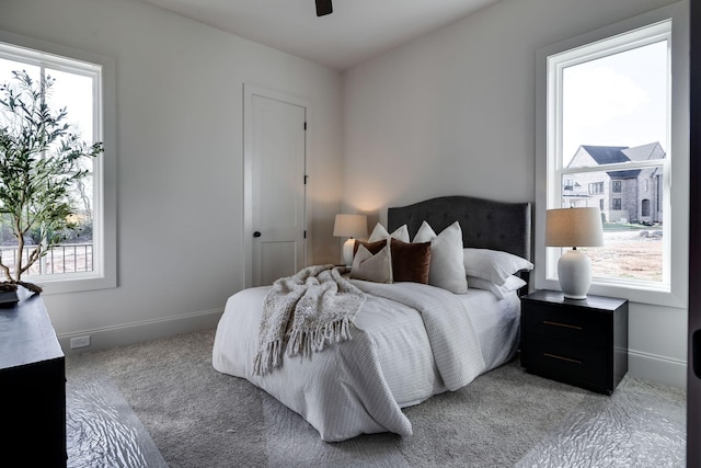 bedroom with light carpet and ceiling fan