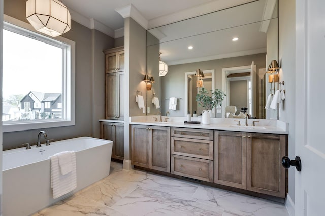 bathroom featuring crown molding, vanity, and a bathing tub