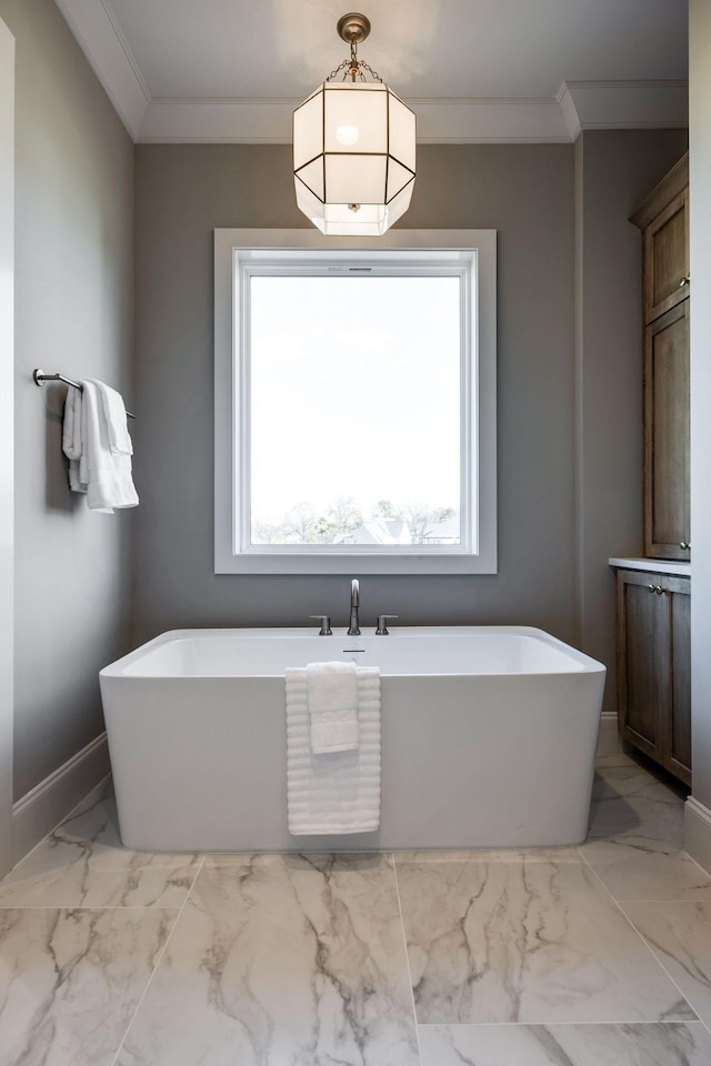 bathroom with a washtub and crown molding