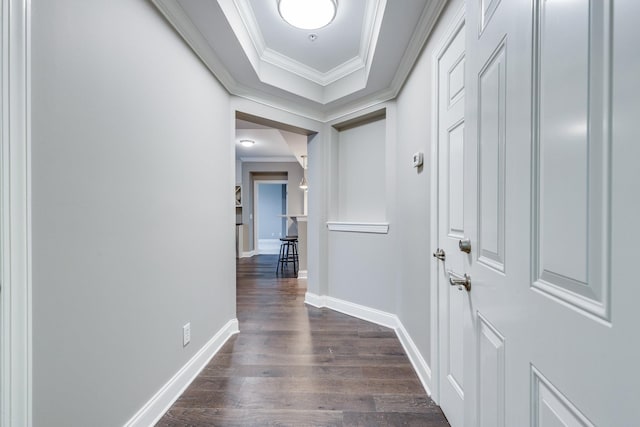 corridor featuring ornamental molding and dark hardwood / wood-style flooring