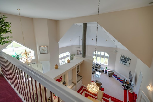 interior space featuring a high ceiling and carpet floors