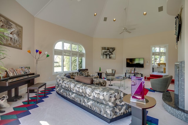 living room with ceiling fan, high vaulted ceiling, and plenty of natural light