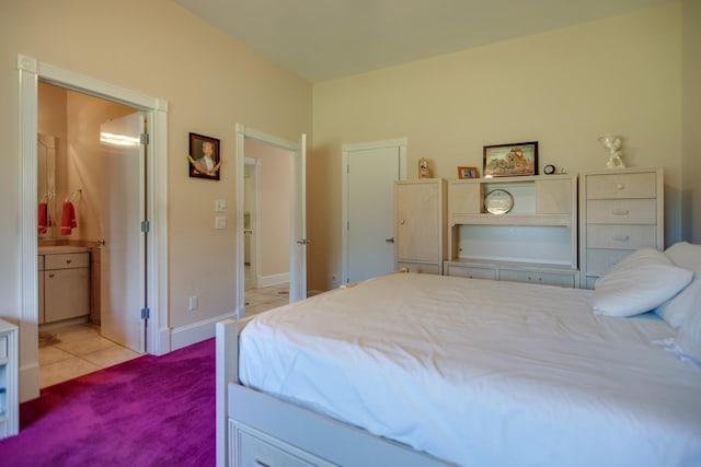 tiled bedroom featuring ensuite bathroom