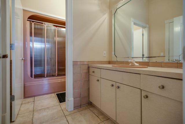 bathroom with washtub / shower combination, vanity, and tile patterned floors