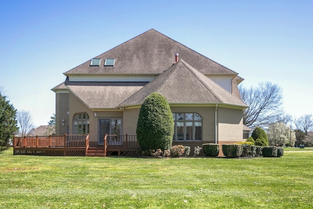 back of house with a lawn and a deck