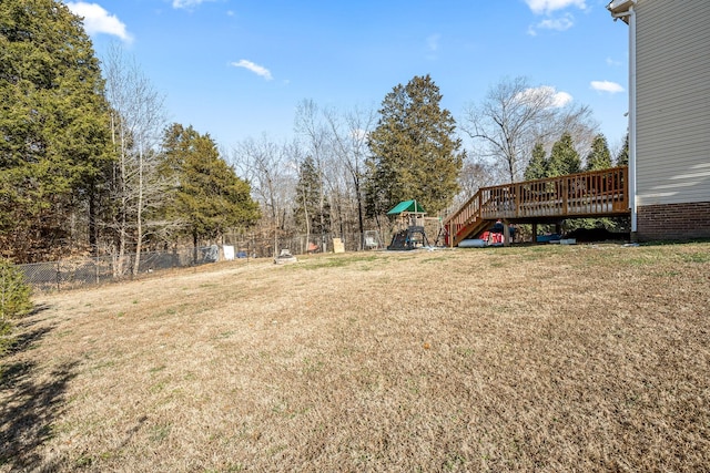 view of yard with a playground and a wooden deck