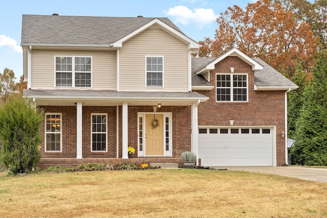 view of front property featuring a porch, a front yard, and a garage