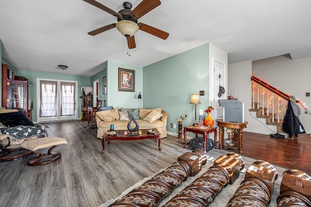 living room featuring a textured ceiling, hardwood / wood-style floors, and ceiling fan