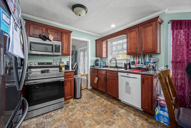 kitchen with a textured ceiling, appliances with stainless steel finishes, ornamental molding, and sink