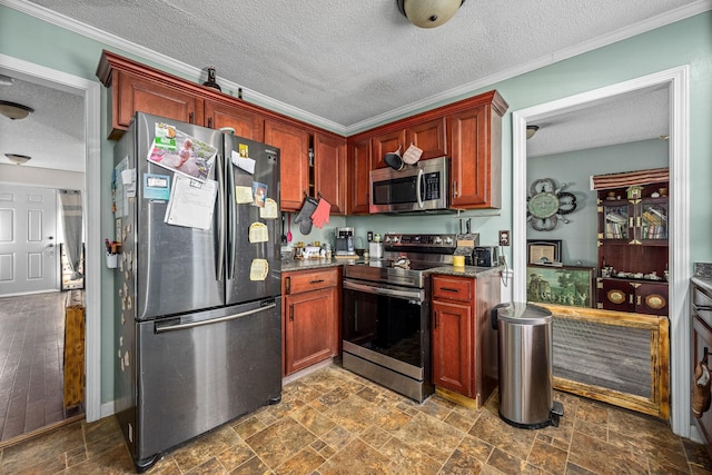 kitchen featuring stainless steel appliances, a textured ceiling, and crown molding