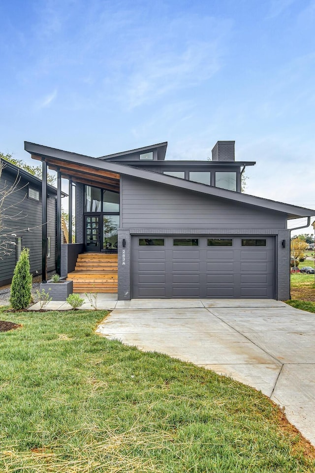 modern home with a front yard and a garage