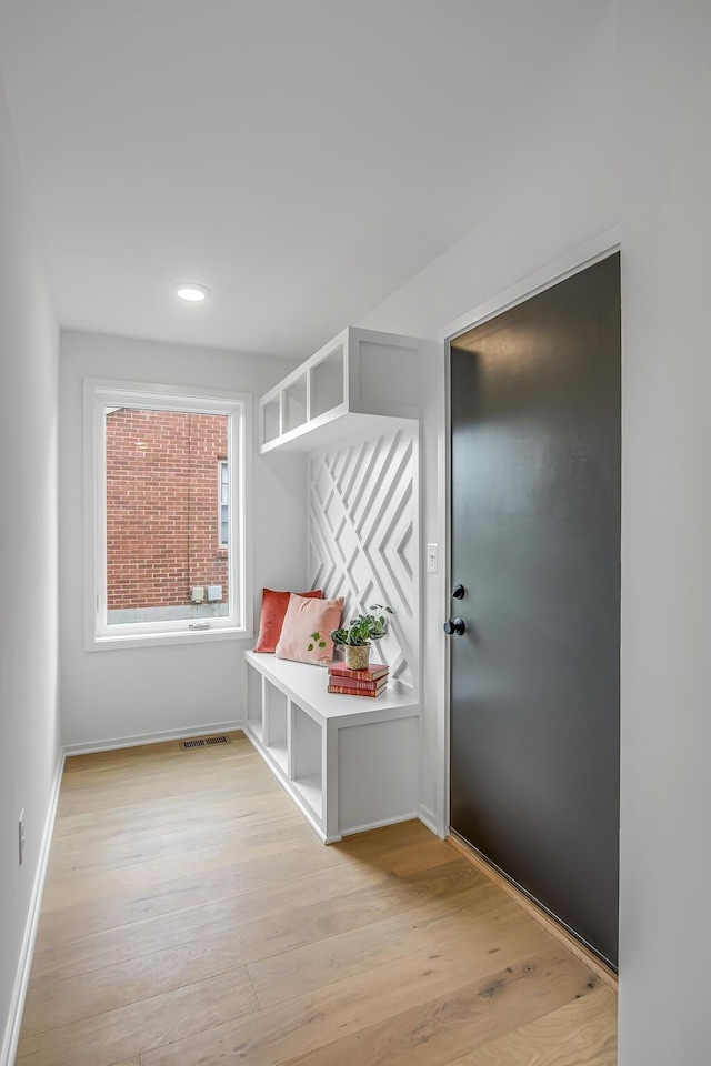 mudroom with light hardwood / wood-style floors