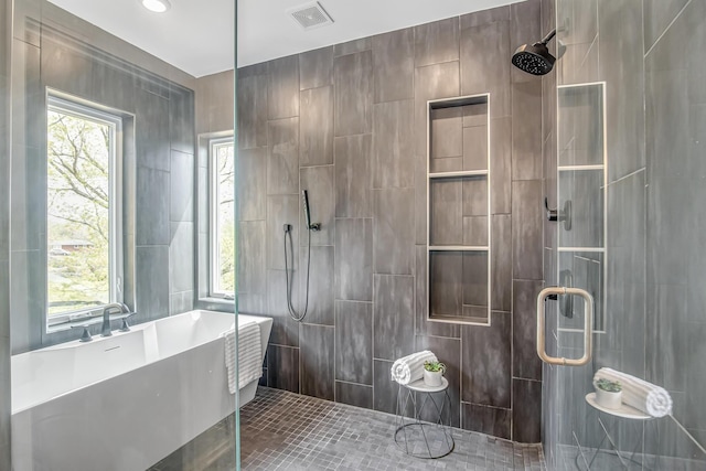 bathroom with tile walls, tile patterned floors, and plus walk in shower