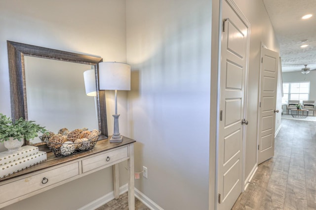 hallway featuring a textured ceiling and hardwood / wood-style floors