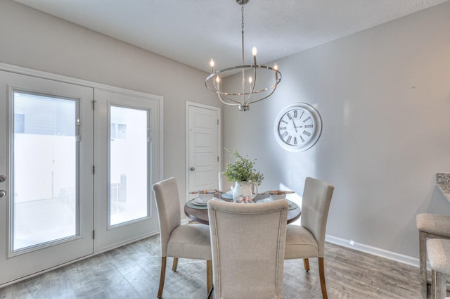 dining room featuring a chandelier and wood-type flooring