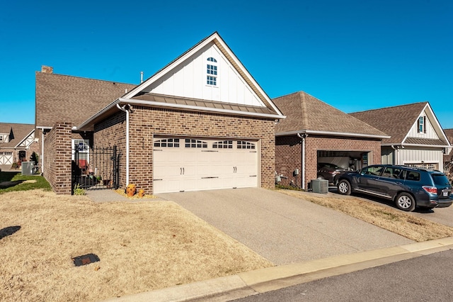 view of front of property featuring central AC and a garage